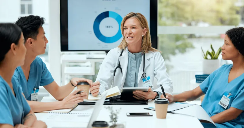 a group of doctors sitting around a table.