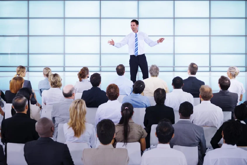 a man is giving a presentation to a group of people.